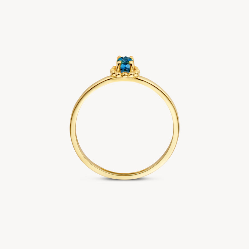 14k geelgouden ring met kleine blauwe topaas solitaire steen.