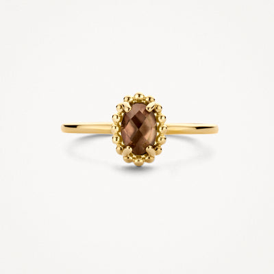 Bague en or 14k avec un cristal de roche brun ovale et un bord perlé.
