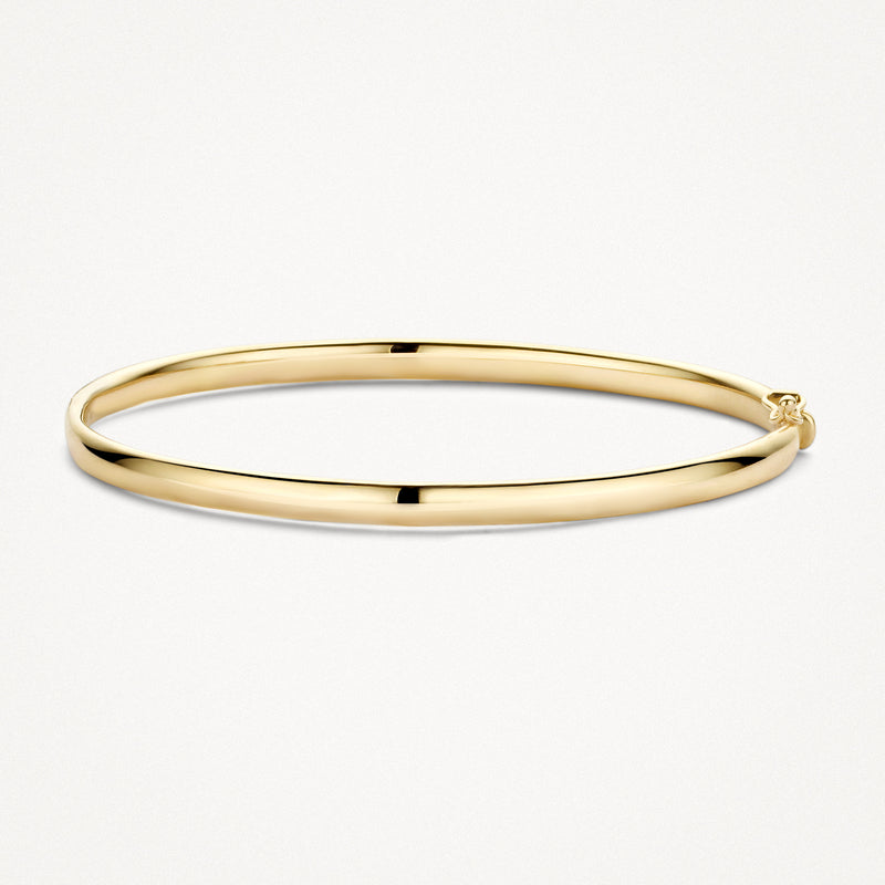 Dunne gladde bangle van 14k geel goud met een glanzende afwerking.