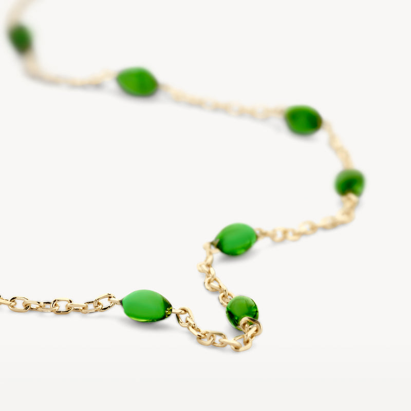 Armband van 14k geel goud met groene resin druppelvormen en fijne schakels.
