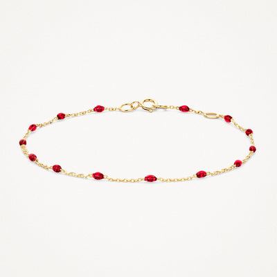 14k geelgouden armband met fijne schakels en rode resin kralen, bicolor goud detail.