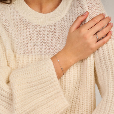 Fijne 14k witgouden ring met zirkonia op slanke vinger, minimalistisch design.