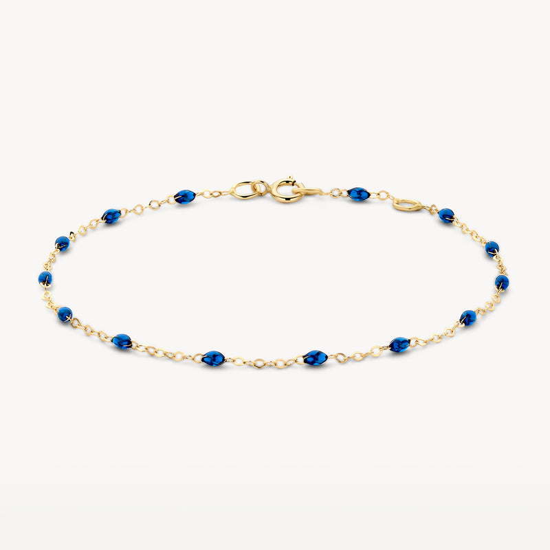 Bracelet fin en or 14k avec des petits maillons en résine bleue.
