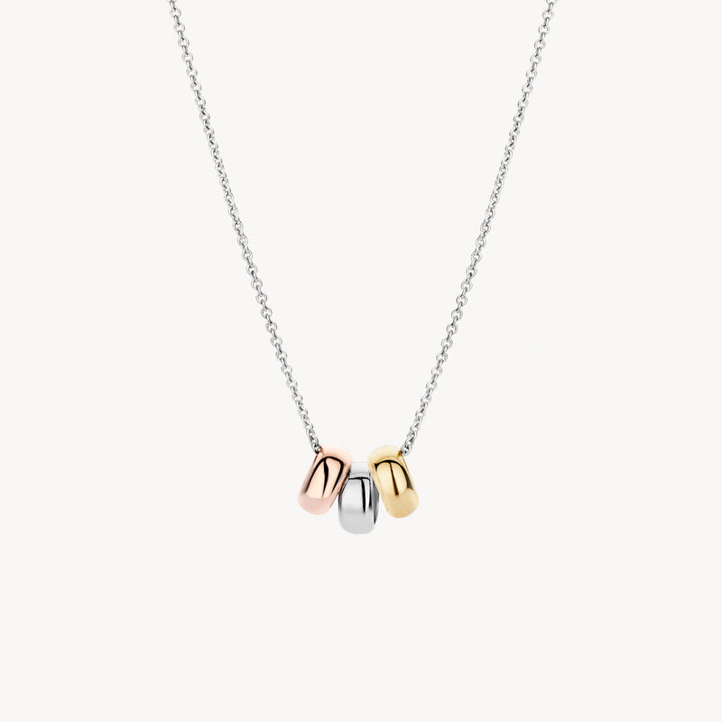 Bicolor goud ketting met hangers van 14k wit, rosé en geel goud aan fijne ketting.