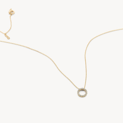 14k gold fine link chain link with round pendant set with Zirconias.