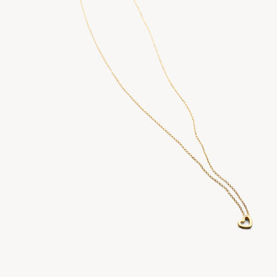 14k yellow gold fine link chain with small heart-shaped pendant.