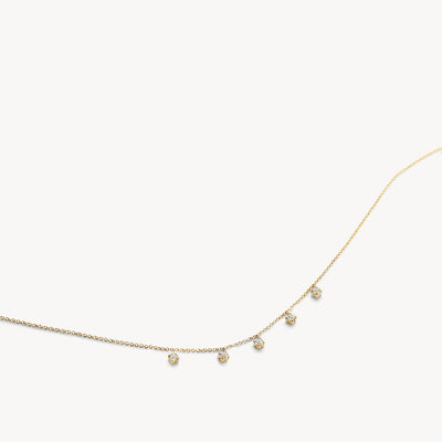 Bicolor goud ketting met fijne schakels en hangende zirkonia's in 14k goud, wit en rosé.