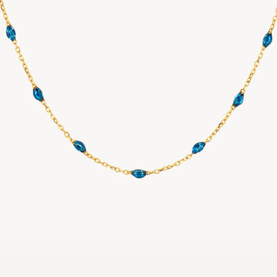 14k geelgouden ketting met delicate schakels en kleine blauwe resin steentjes.