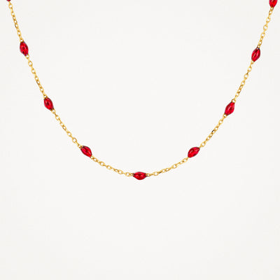 14k geelgouden ketting met fijne schakels en kleine rode resin kralen.