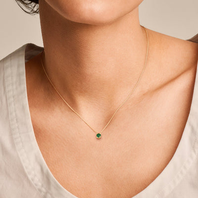 Collier avec un pendentif en émeraude sur une fine chaîne en Or jaune 14k.