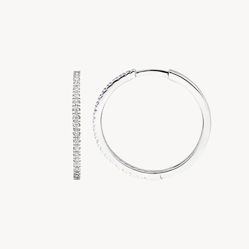 Oorringen van 14k wit goud bezet met fonkelende zirkonia stenen, slanke ronde vorm.