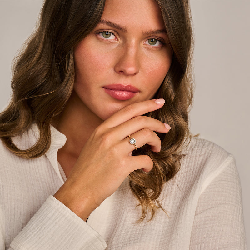 Ring met labdiamant in 14k geelgoud, gedragen aan linkerhand, close-up van hand en gezicht.