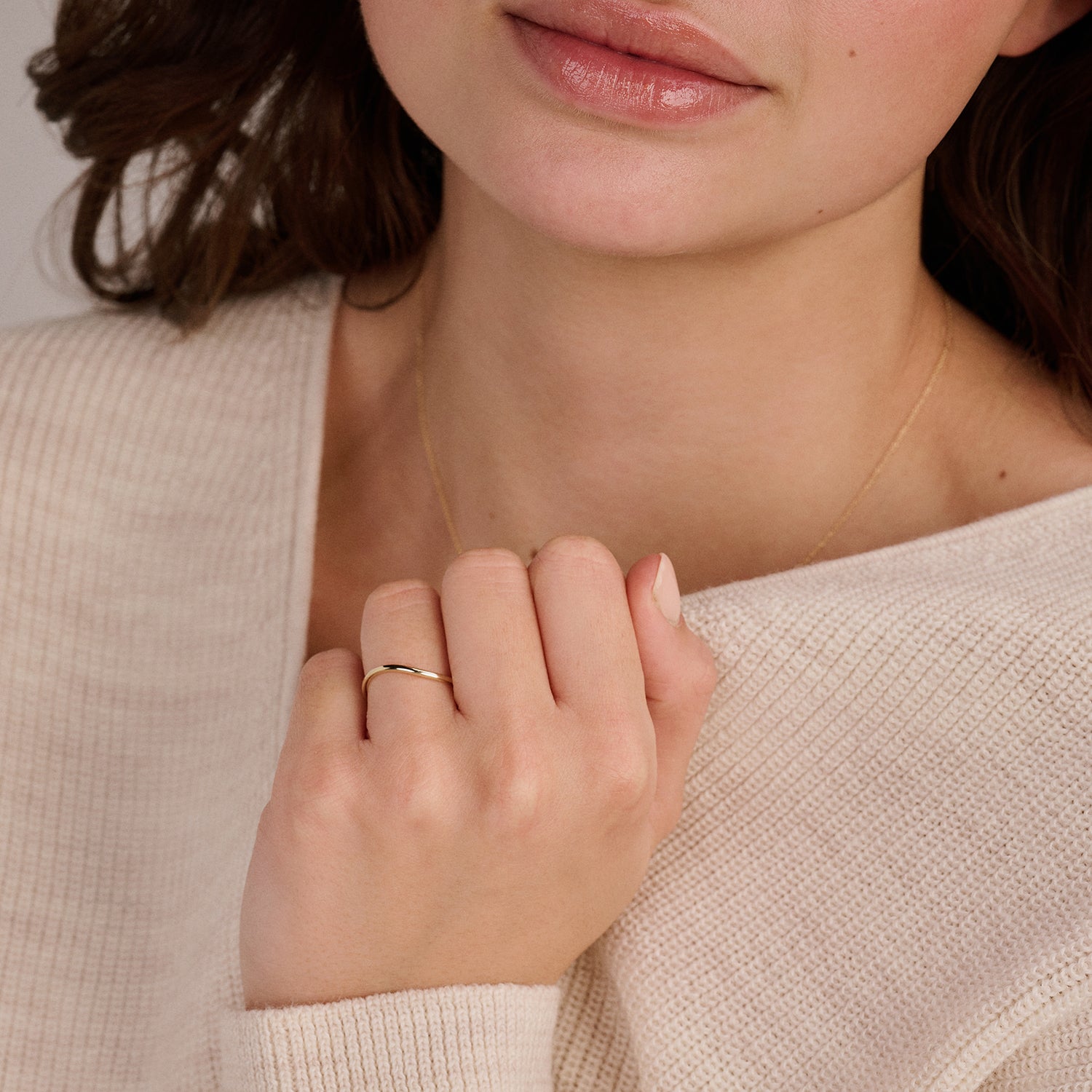 A genuine 14ct yellow gold delicate stacking ring, worn on the finger.