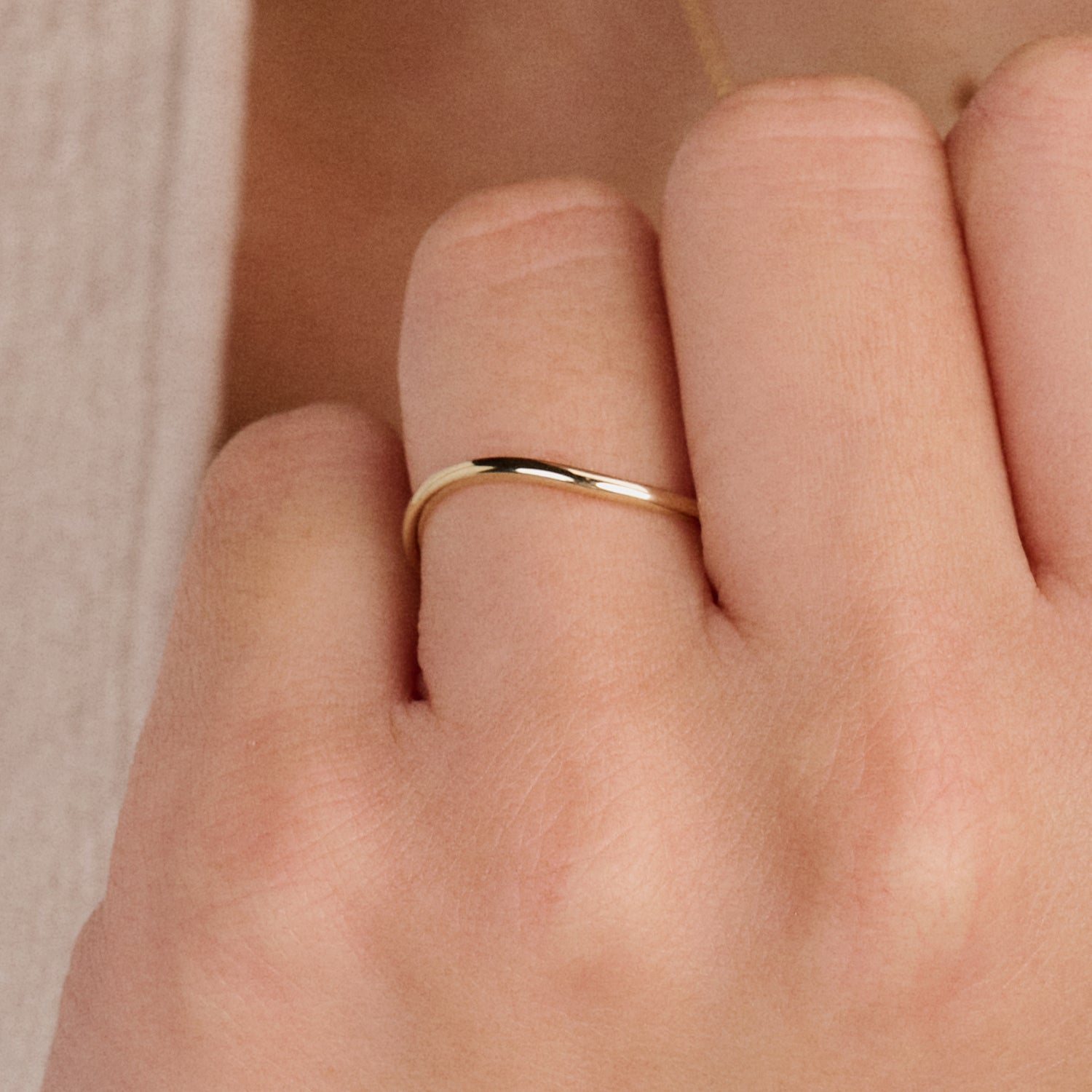 Genuine 14ct yellow gold delicate stacking ring with a smooth band, front view.
