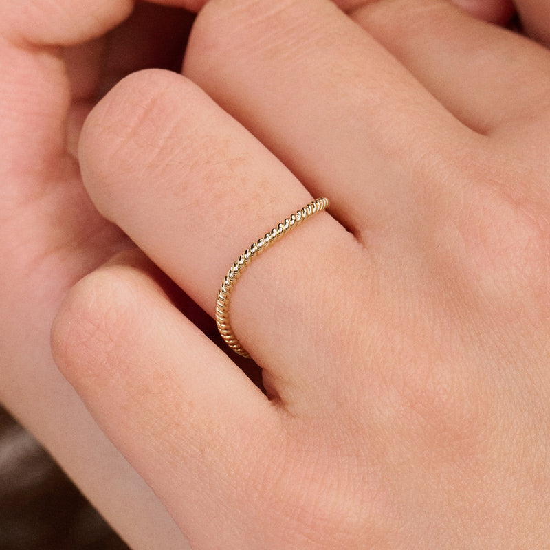 Bague empilable intemporelle en or jaune 14 carats, avec un anneau lisse, vue de face.