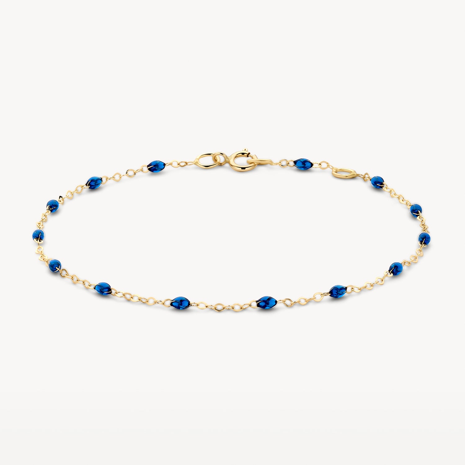 Fijne armband van 14k goud met kleine blauwe resin schakels.