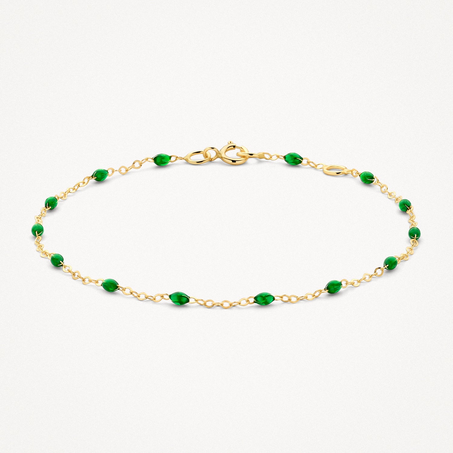 14k goud armband met fijne schakels en kleine groene resin kralen.