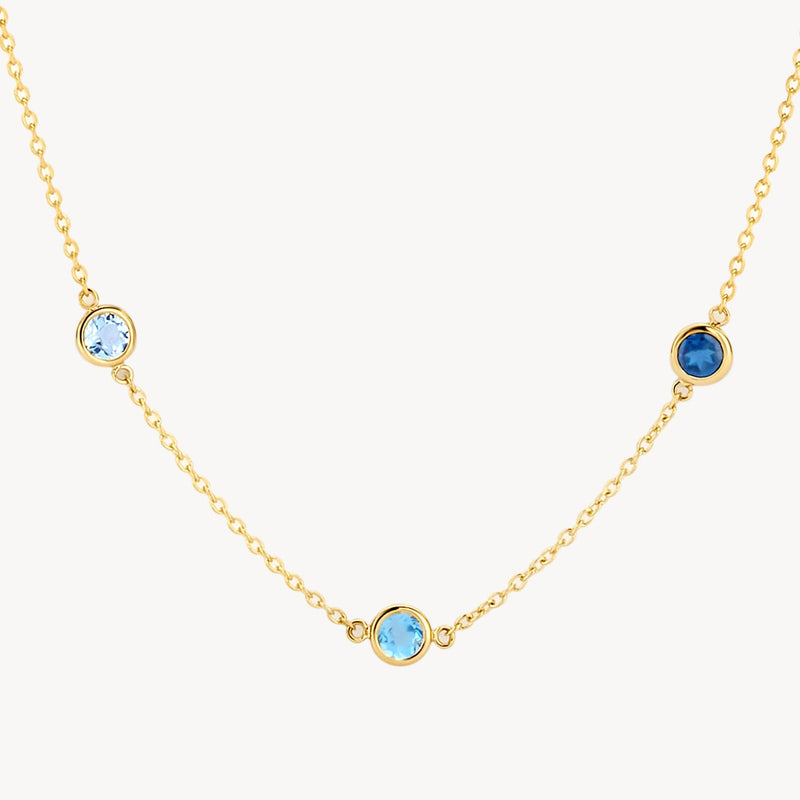 Collier en or jaune 14 carats avec pendentif en topaze bleu ciel, vue de face.