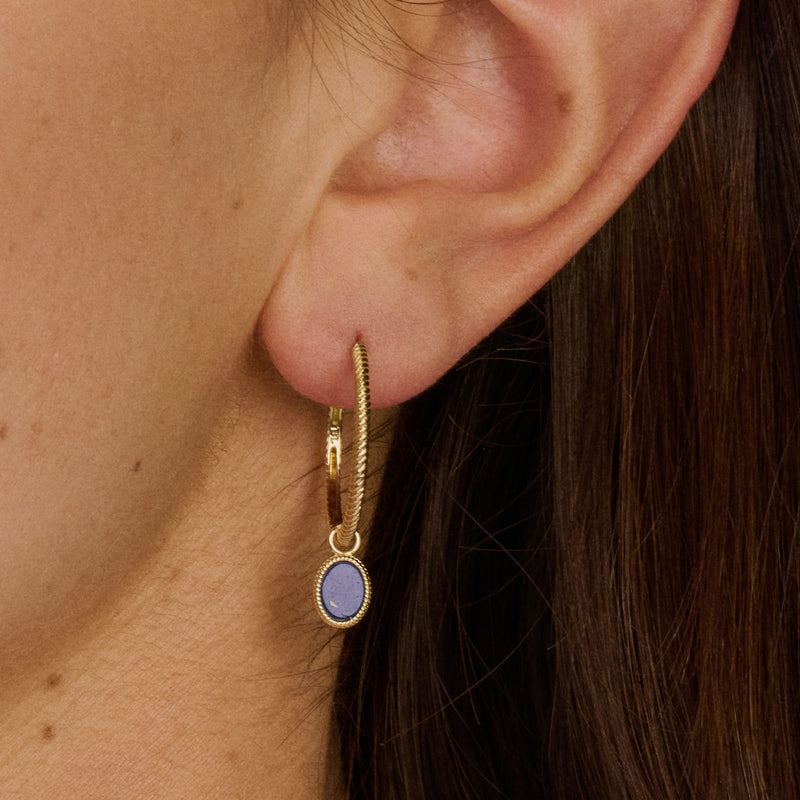 14k goud oorring met gedraaid motief en kleine paarsblauwe hangerset.