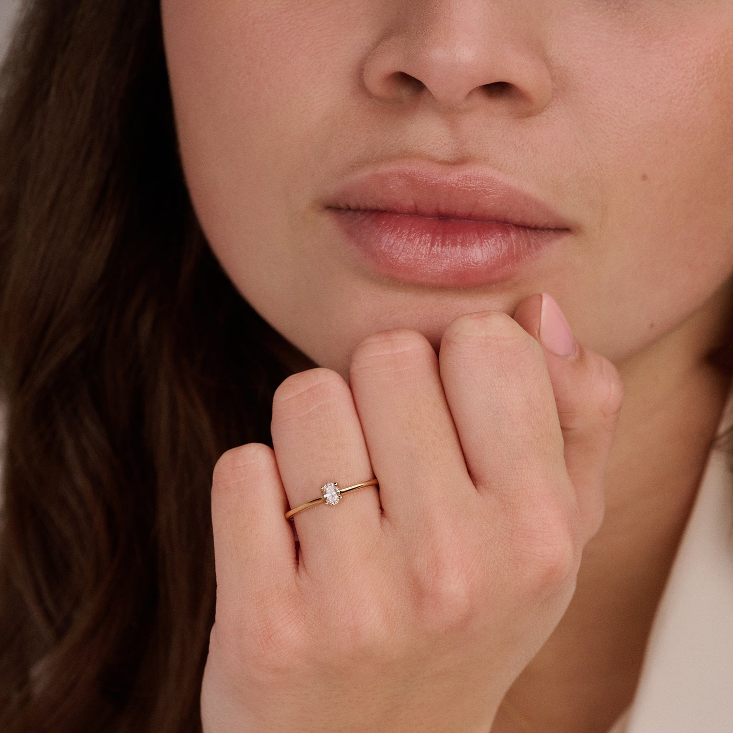14ct yellow gold ring with an oval Lab Grown Diamond, worn on the finger.