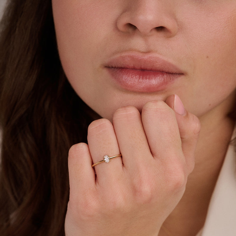 14ct yellow gold ring with an oval Lab Grown Diamond, worn on the finger.