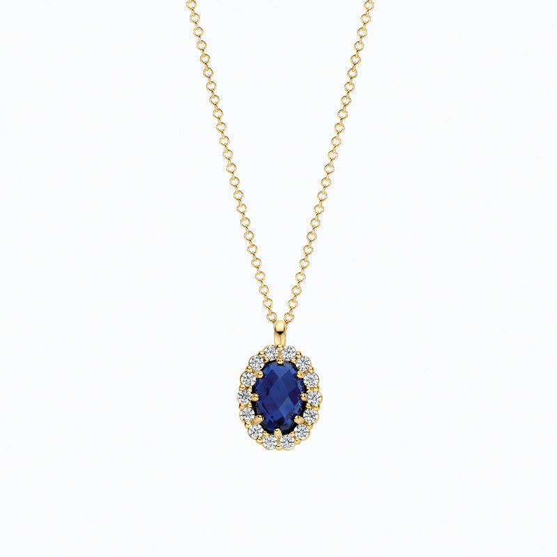 14ct yellow gold necklace with a lab-grown and blue Diamond pendant, close-up.