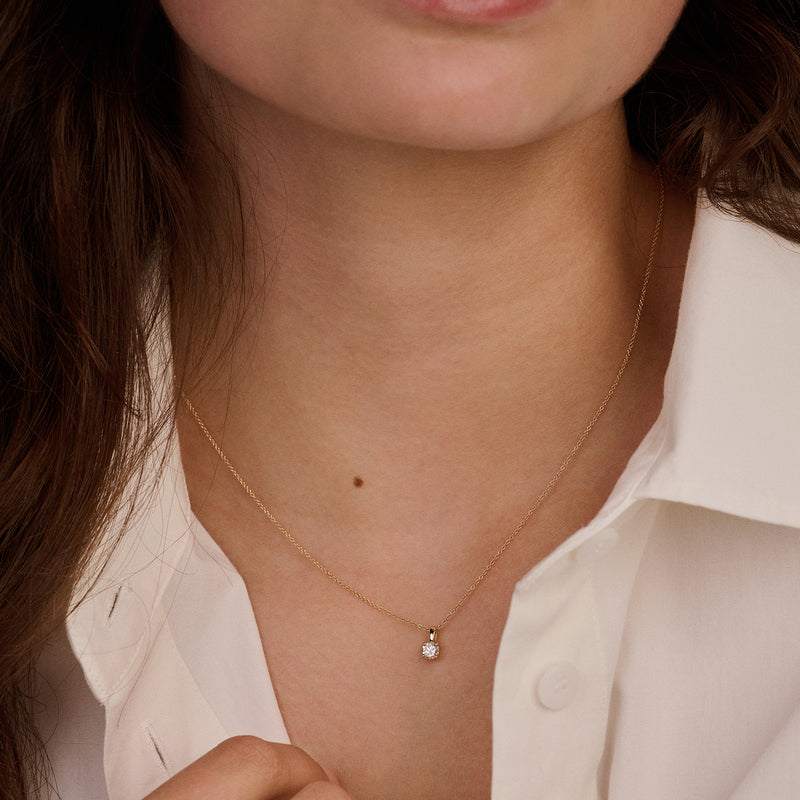14ct yellow gold pendant with Lab Grown Diamond, worn around the neck.